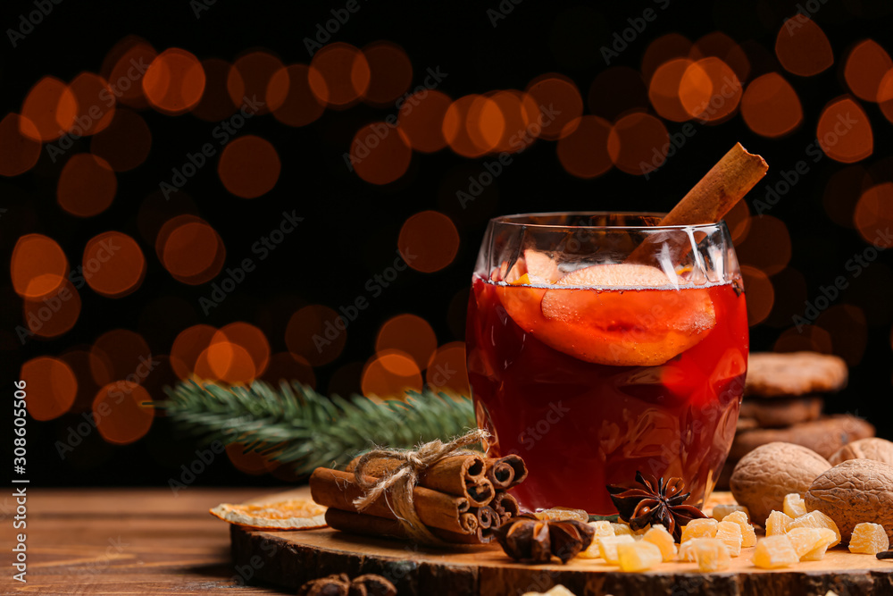 Glass of tasty mulled wine on table