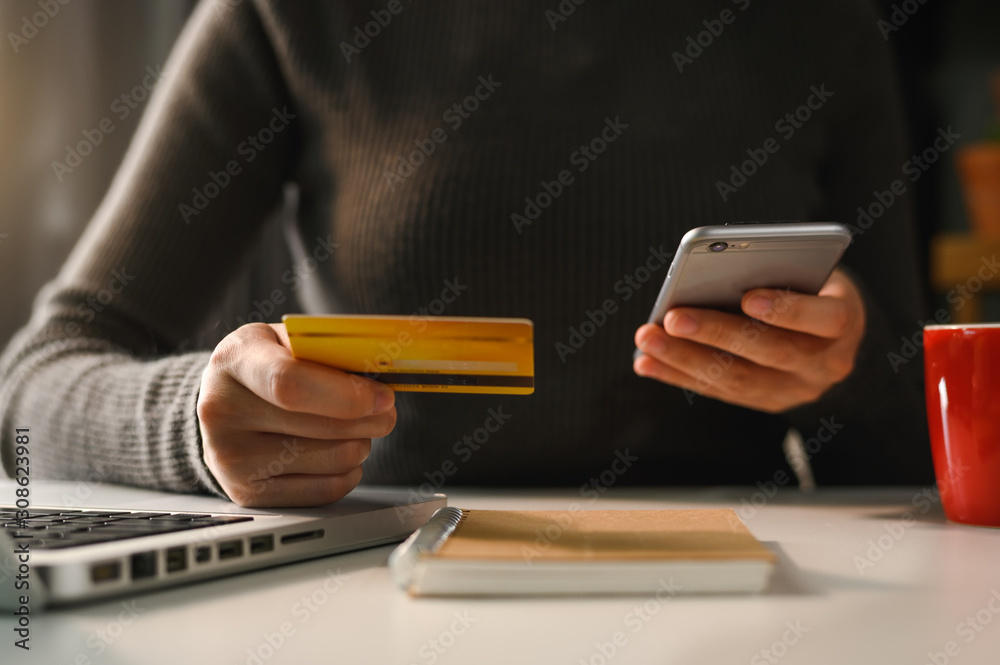 businesswoman hand using smart phone, tablet payments and holding credit card online shopping, omni 