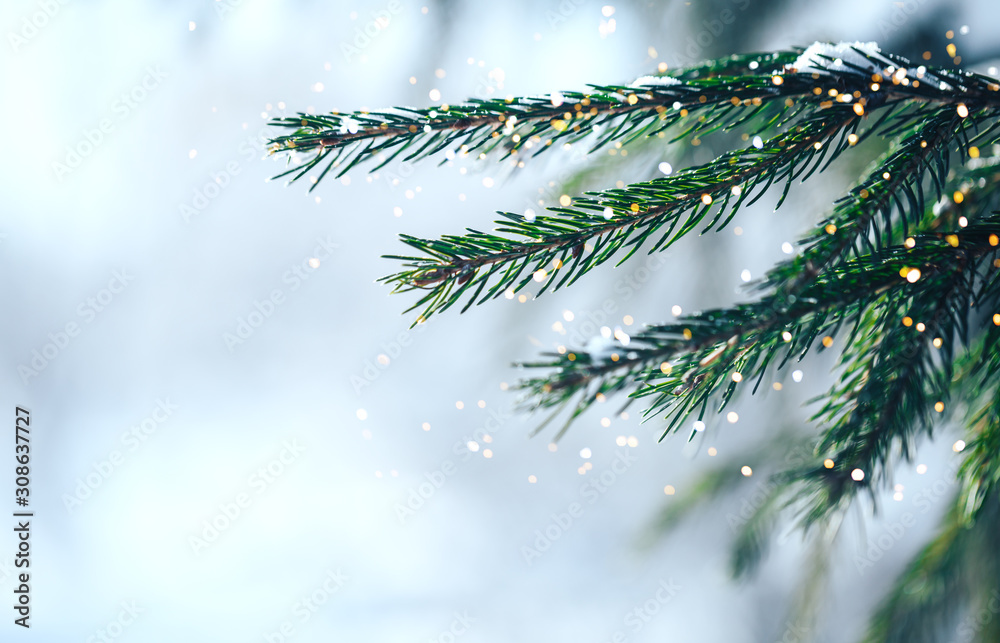 Christmas tree outdoor with snow, lights bokeh around, and snow falling, Christmas atmosphere.