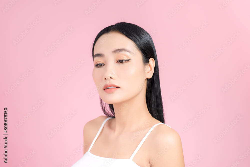 Portrait of Asian healthy skin woman beautiful face close up over pink background