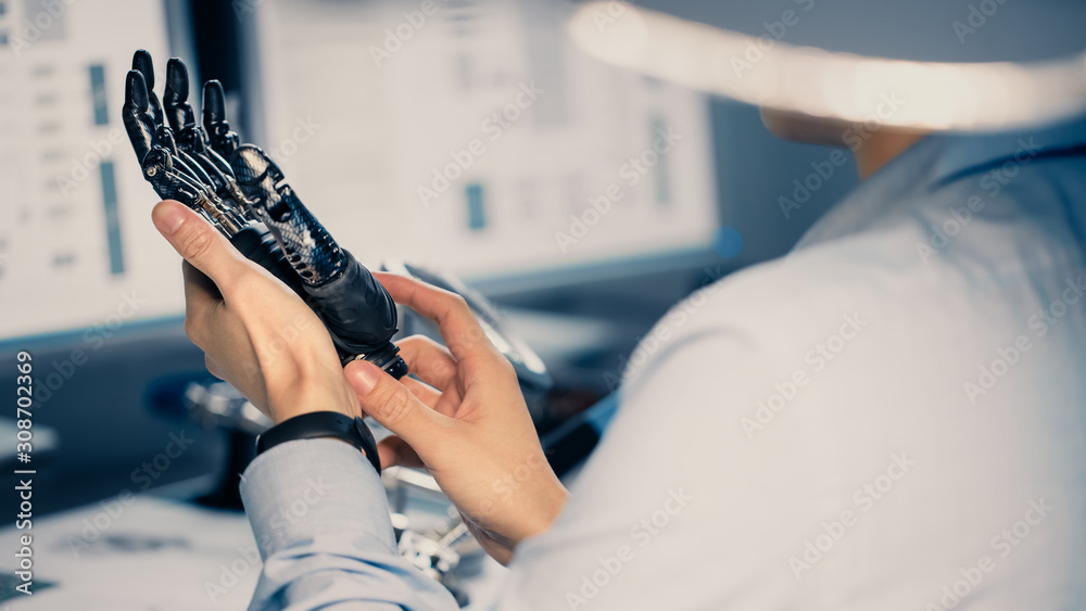 Close Up of a Futuristic Prosthetic Robot Arm Being Tested by a Professional Development Engineer in