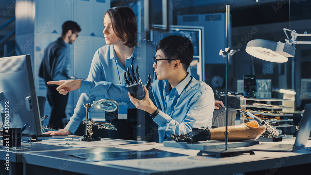 Technological Prosthetic Robot Arm is Tested by Two Professional Development Engineers in a High Tec