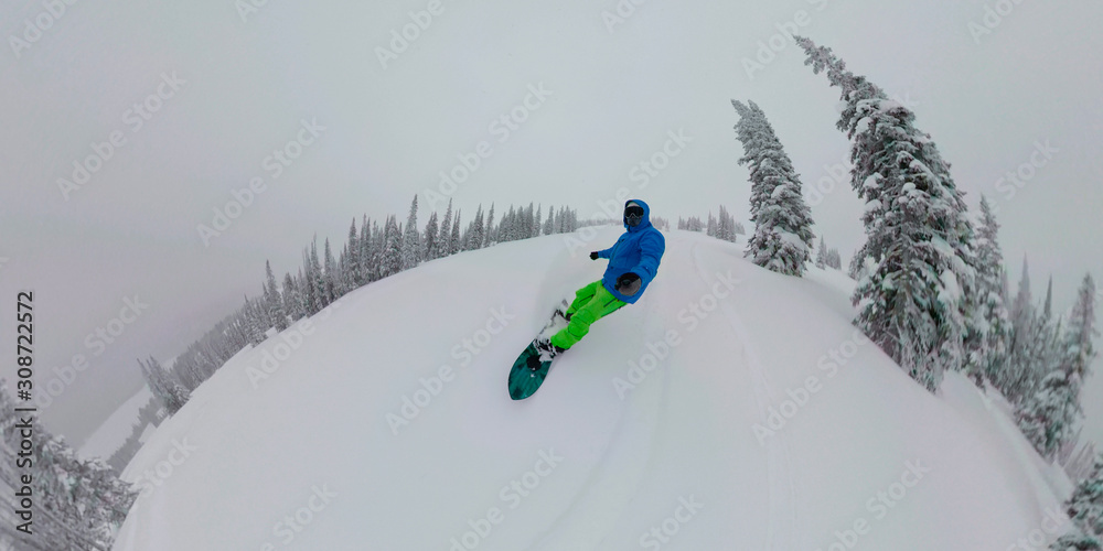 SELFIE: Man takes a selfie while riding his snowboard off piste in the Rockies.