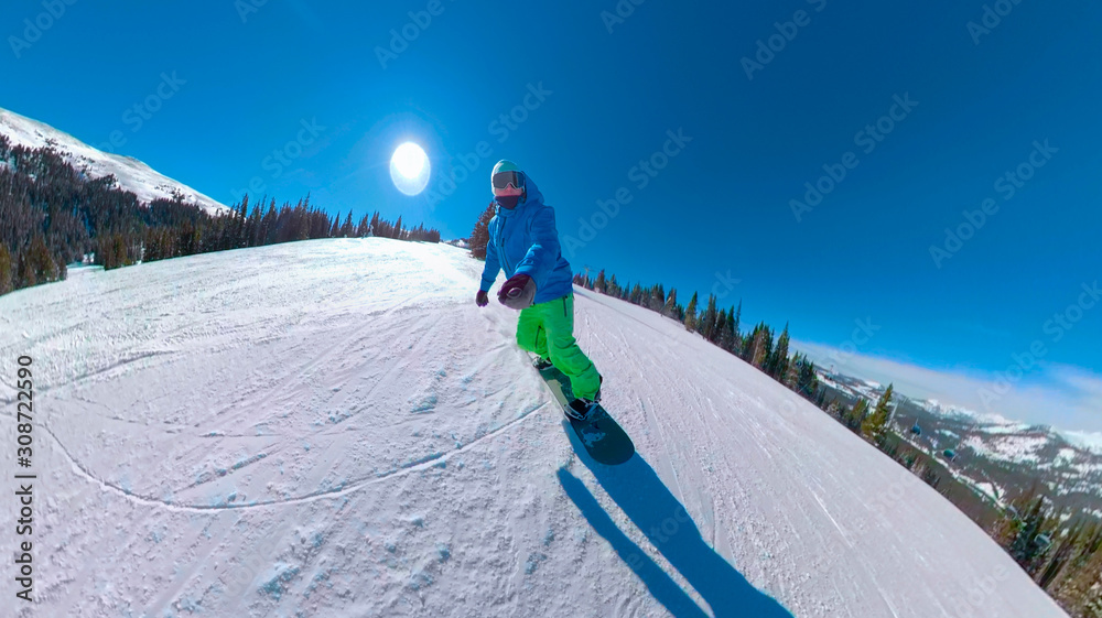 SELFIE: Active tourist rides his snowboard down the groomed slope in Colorado.