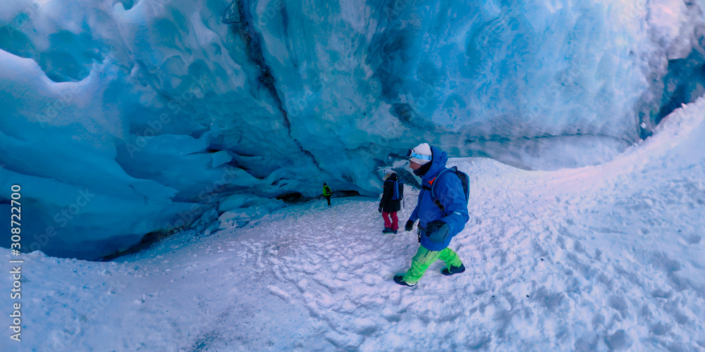 SELFIE: Group of travelers hike and explore the icy caves in Rocky Mountains.