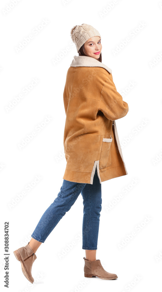 Young woman in winter clothes on white background