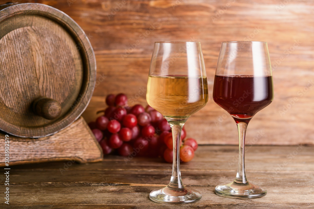 Glasses of different wine on wooden table