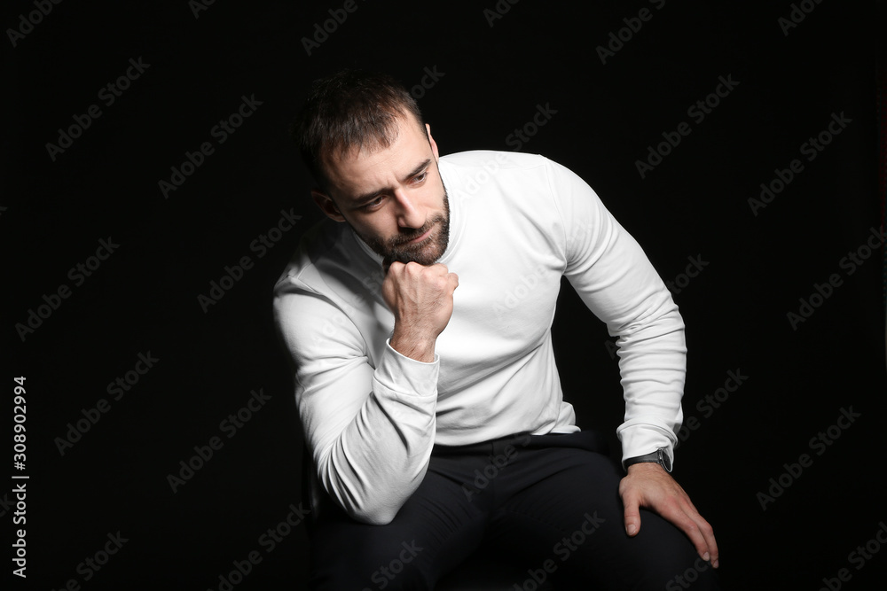 Portrait of young man on dark background