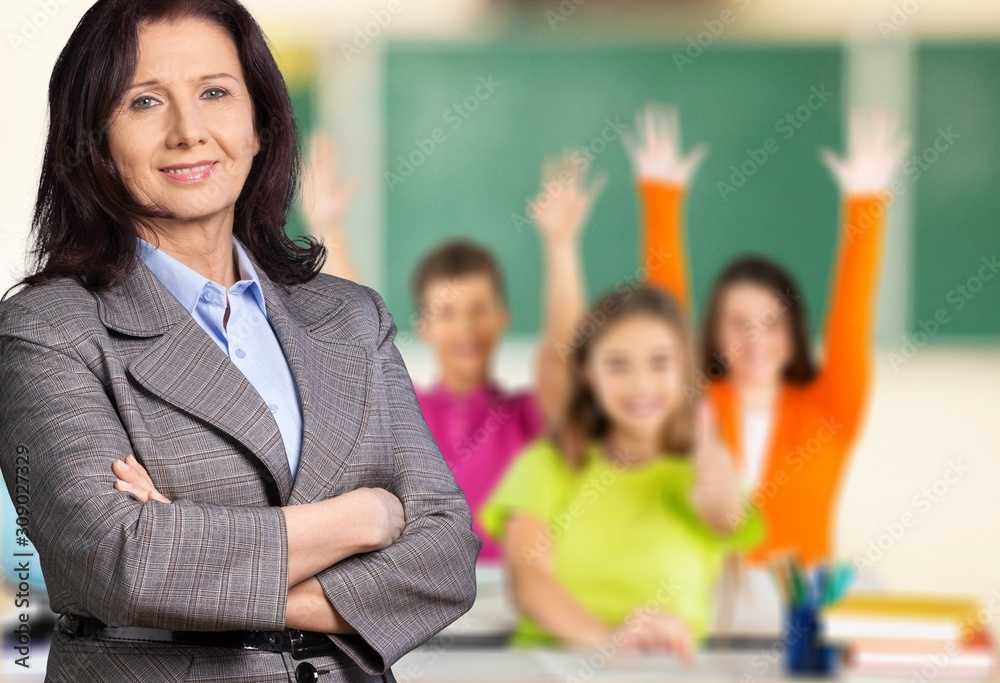 Female teacher with children at class on background