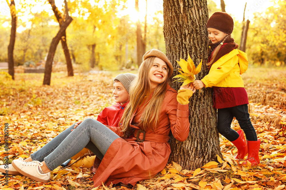 Happy family resting in autumn park