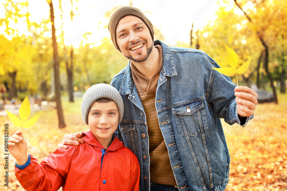 Happy father and son in autumn park