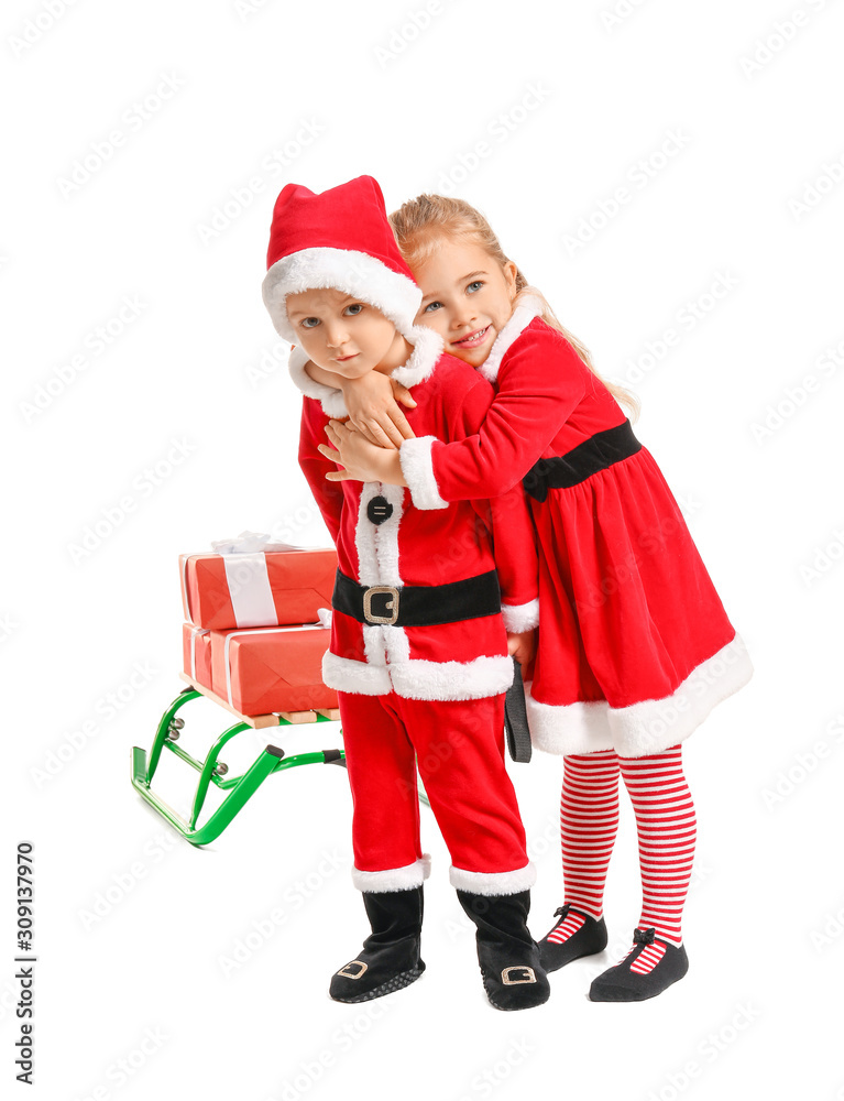 Cute little children in Santa costumes and with Christmas gifts on white background