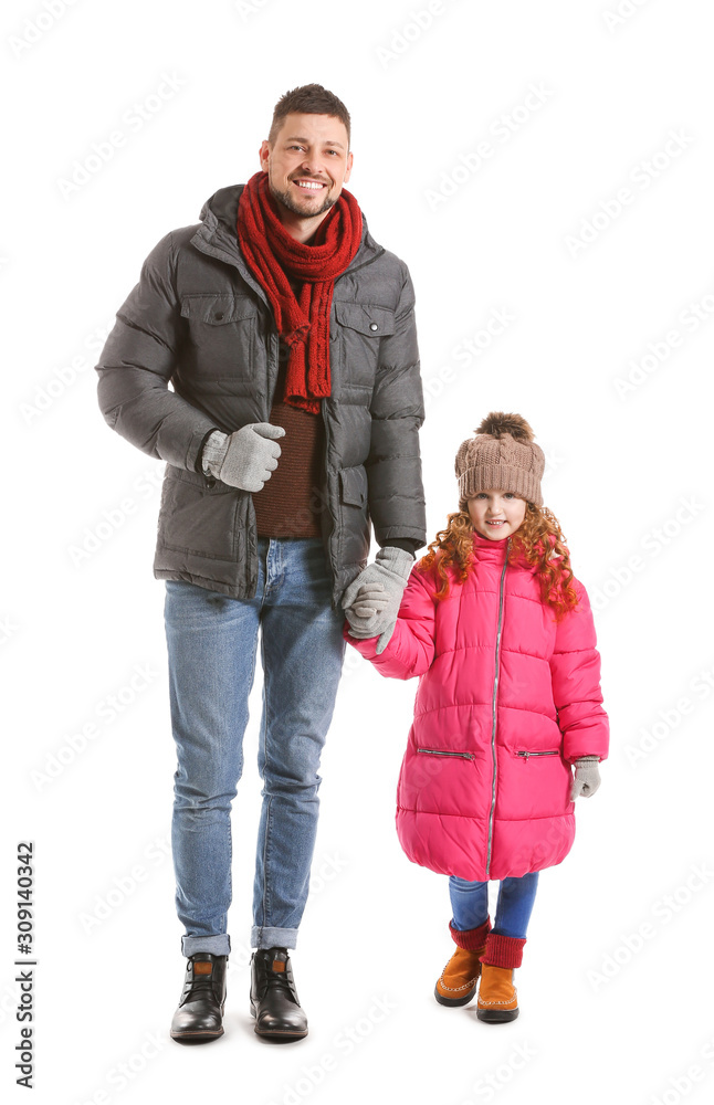 Cute little girl with father in winter clothes on white background