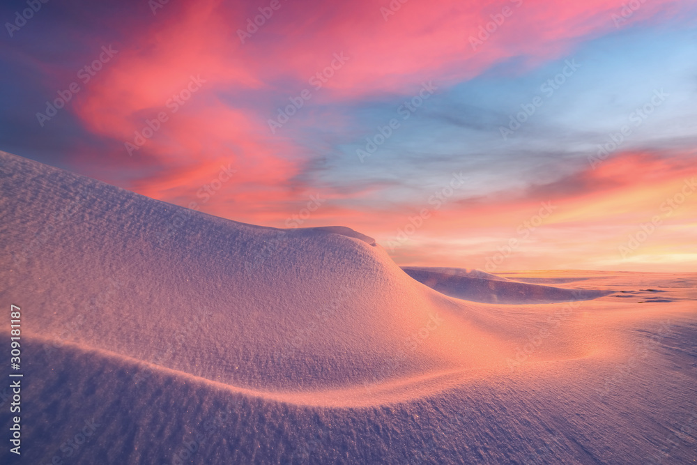 Fantastic winter landscape in snowy mountains glowing by evening sunlight. Dramatic wintry scene wit