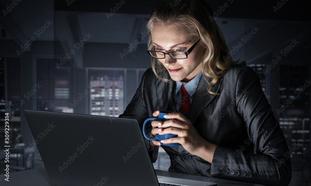 Businesswoman at desk looking at laptop