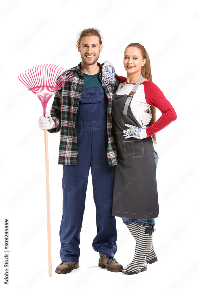 Couple with rake for autumn leaves clean-up on white background