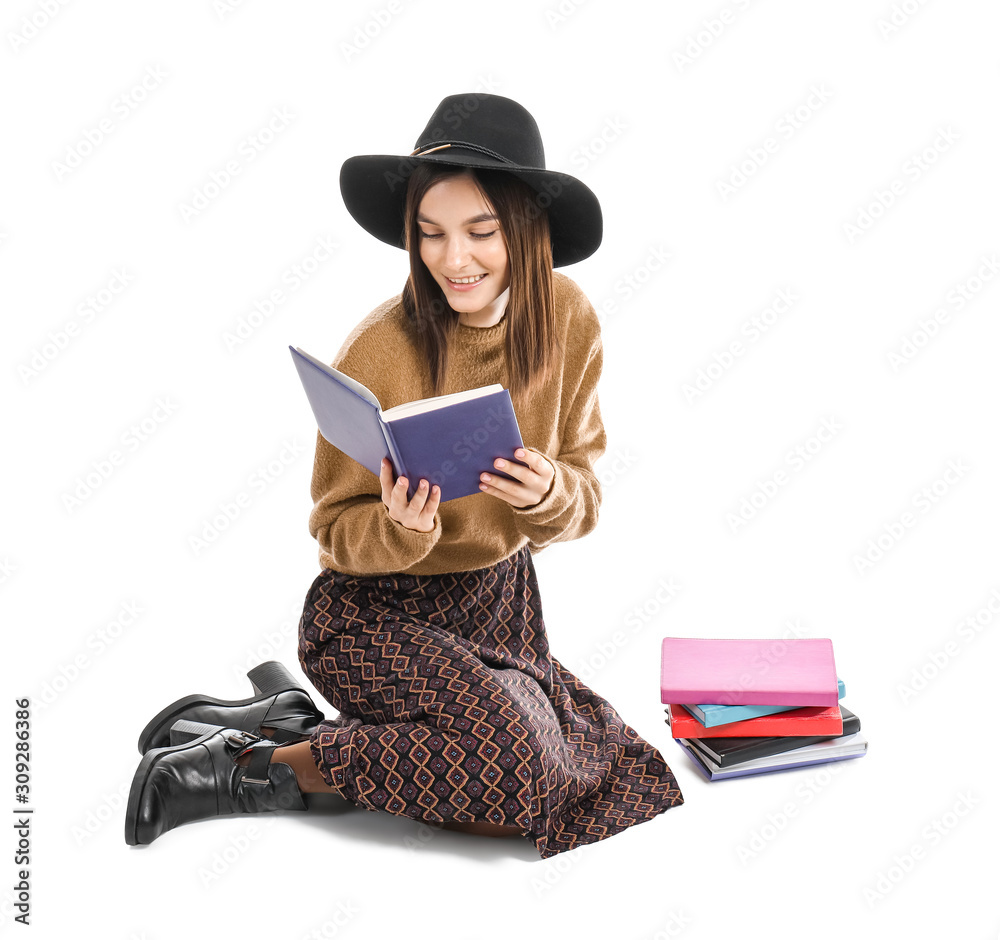 Beautiful young woman reading book on white background