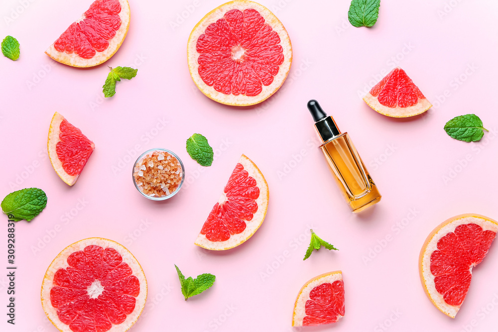 Composition with grapefruit essential oil on color background