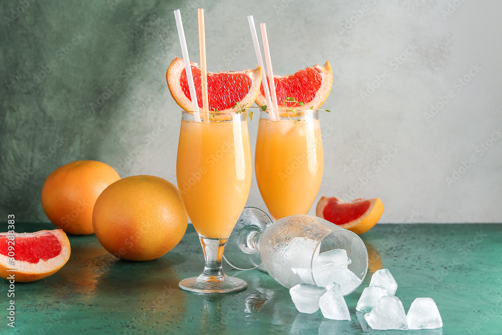 Glasses of fresh citrus juice on table