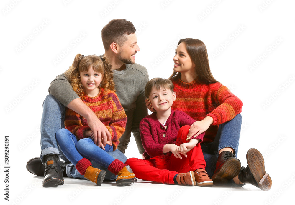 Happy family in winter clothes on white background