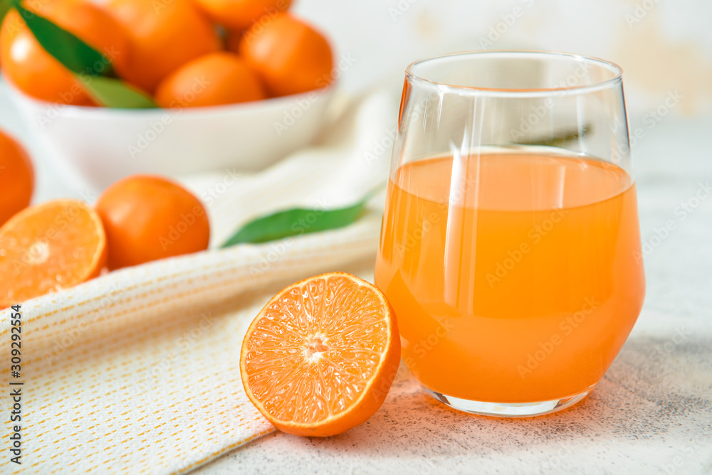 Glass of sweet tangerine juice on table