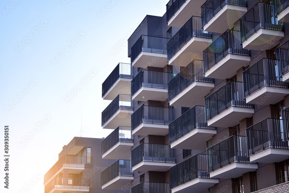 Sun rays light effects on urban buildings. Fragment of modern residential apartment with flat buildi