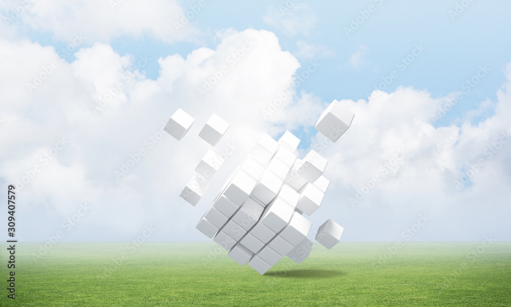 Abstract flying white cubes on green meadow