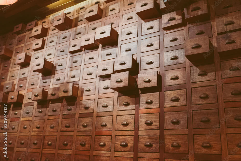 Old wooden textured drawers background in chinese herbal medicine shop in china.Vintage asian object