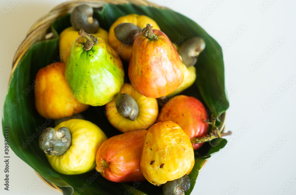 Fresh Cashew nuts on banana leaf.Raw cashews in wooden bowl.