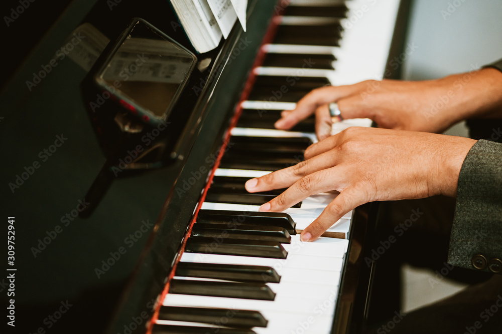 Man hands on grand piano for worship in Church.Male pianist Playing classic piano.Professional music