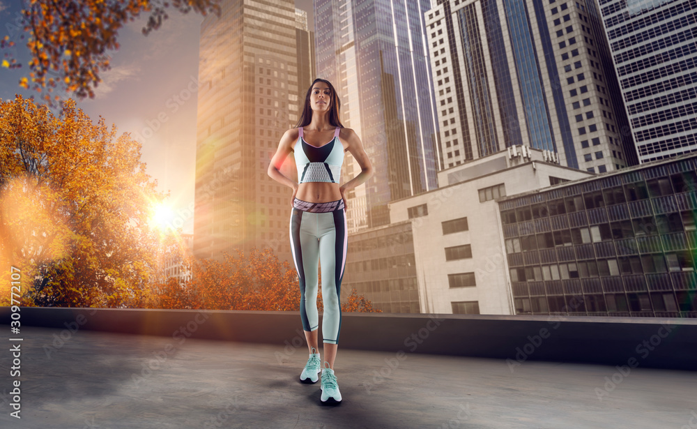 Athlete woman run on the city street. Sport tight clothes. Bright sunset, city background. Horizonta