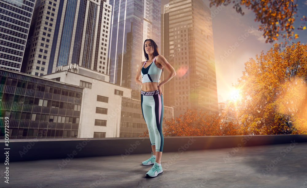 Athlete woman run on the city street. Sport tight clothes. Bright sunset, city background. Horizonta