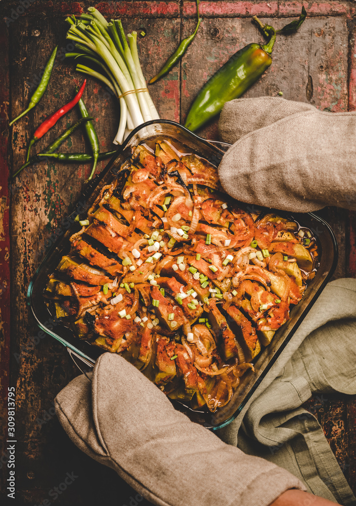 Turkish traditional dish. Flat-lay of oven roasted pumpkin with onion and olive oil in baking tray i