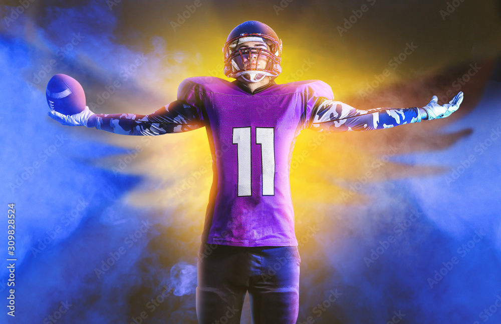 American football player in smoke on dark background