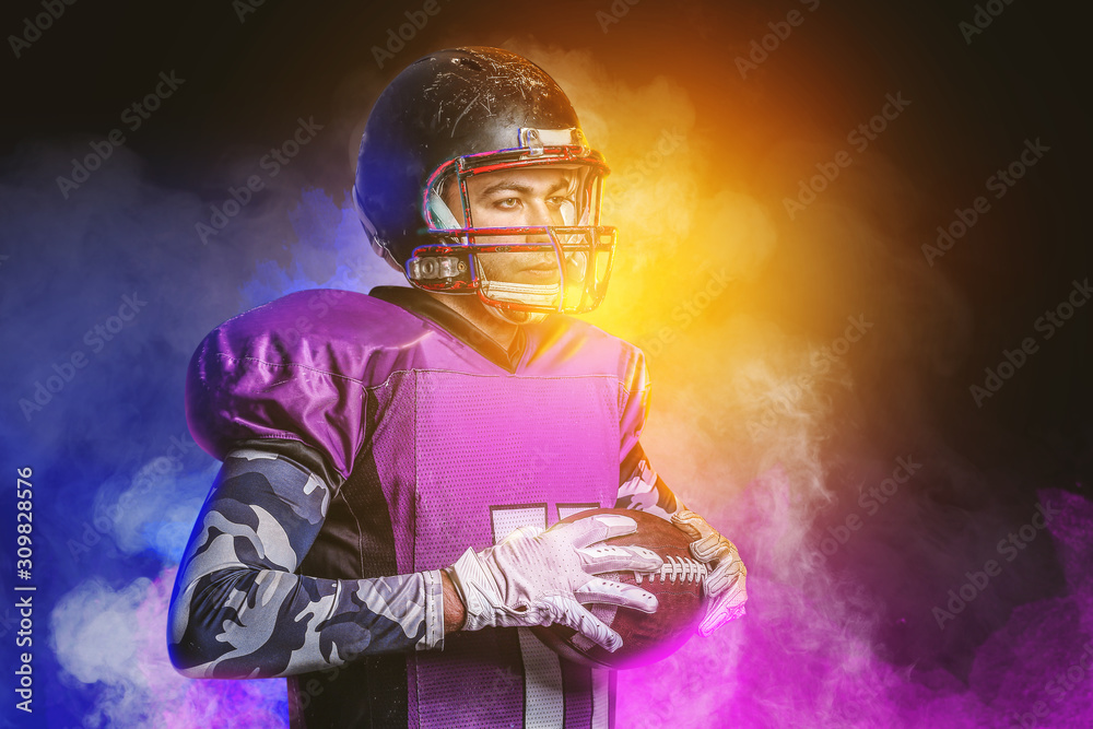 American football player in smoke on dark background