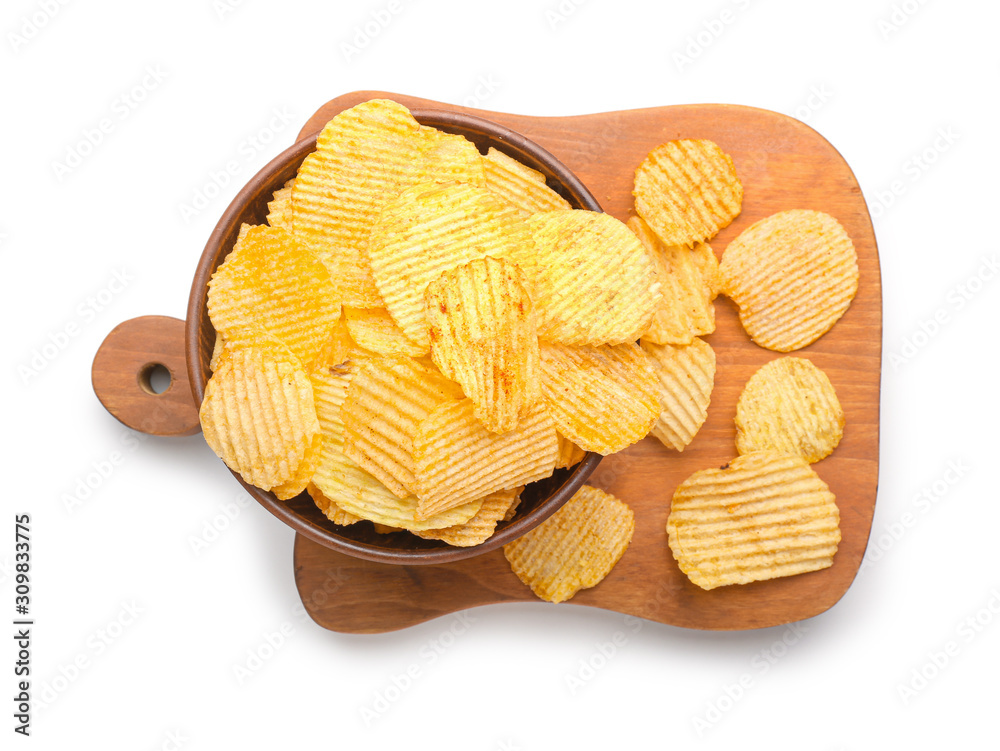 Bowl and board with tasty potato chips on white background