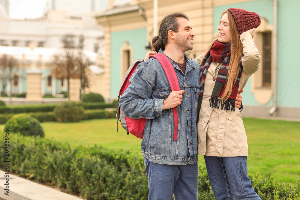 Happy couple walking in autumn city