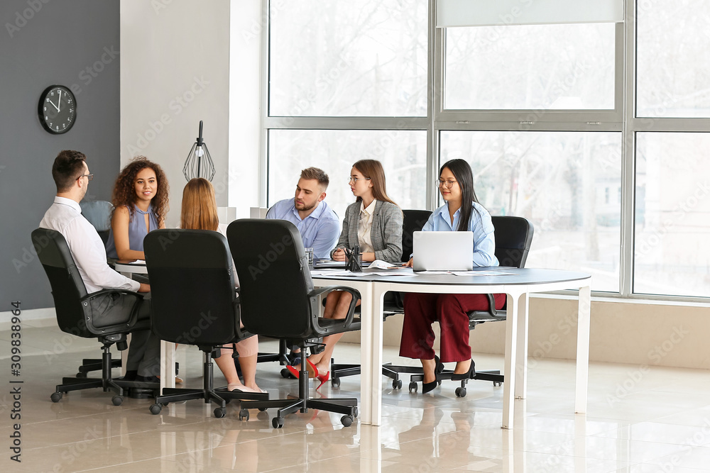 Colleagues discussing issue at business meeting in office