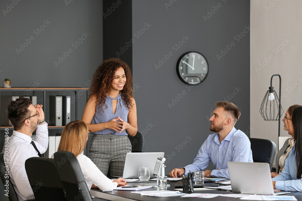 Colleagues discussing issue at business meeting in office