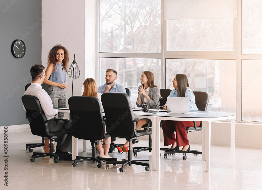 Colleagues discussing issue at business meeting in office