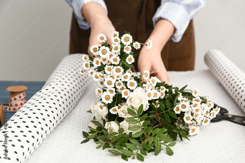 Female florist making beautiful bouquet, closeup