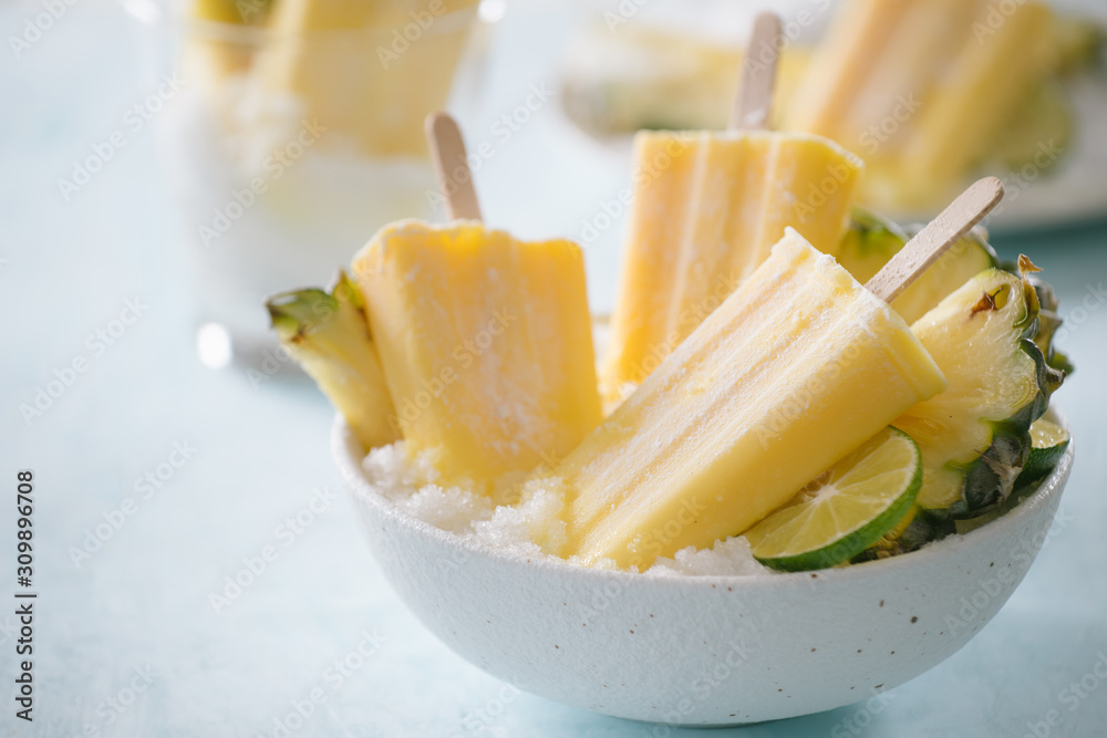 Homemade Pineapple Popsicles on a bowl(selective focus; close-up shot)