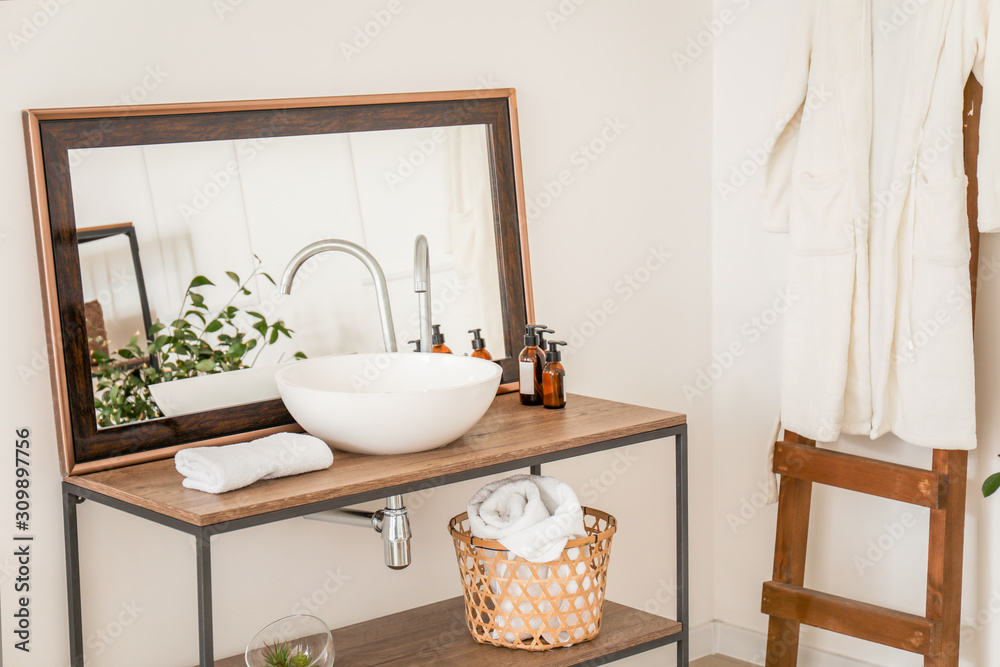 Interior of clean bathroom with sink near white wall