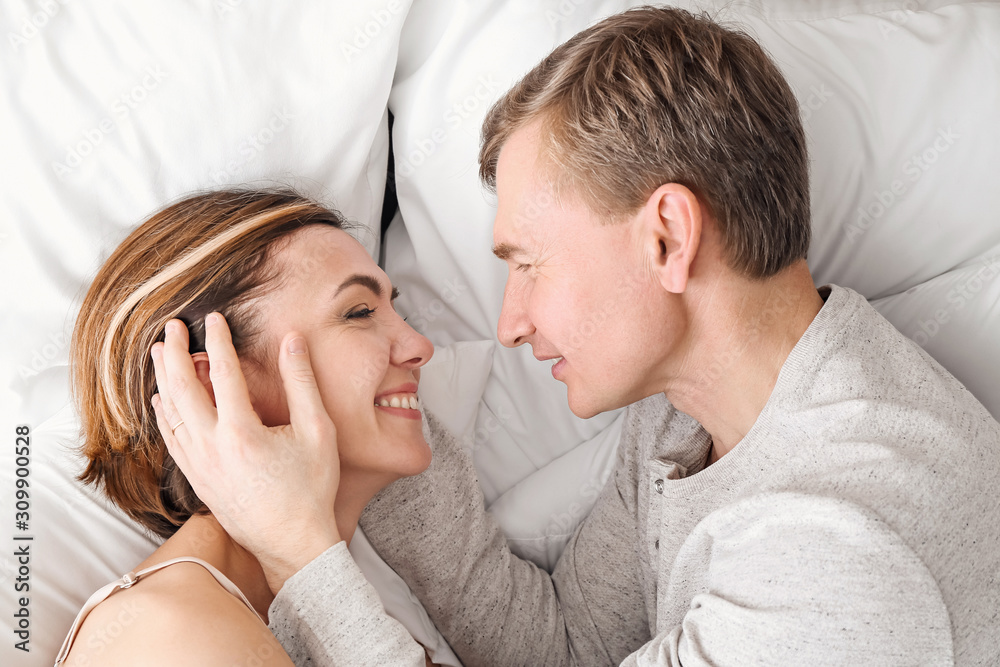 Beautiful couple lying in bed