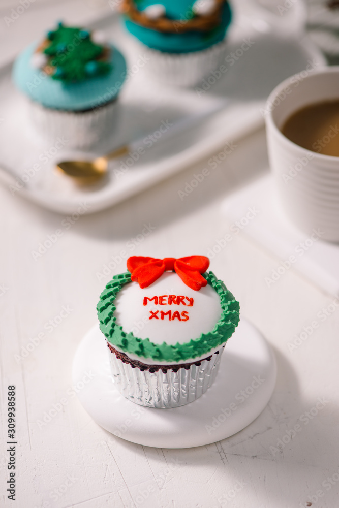 Seasonal festive christmas mini dessert cupcakes in traditional red green decorative symbols element