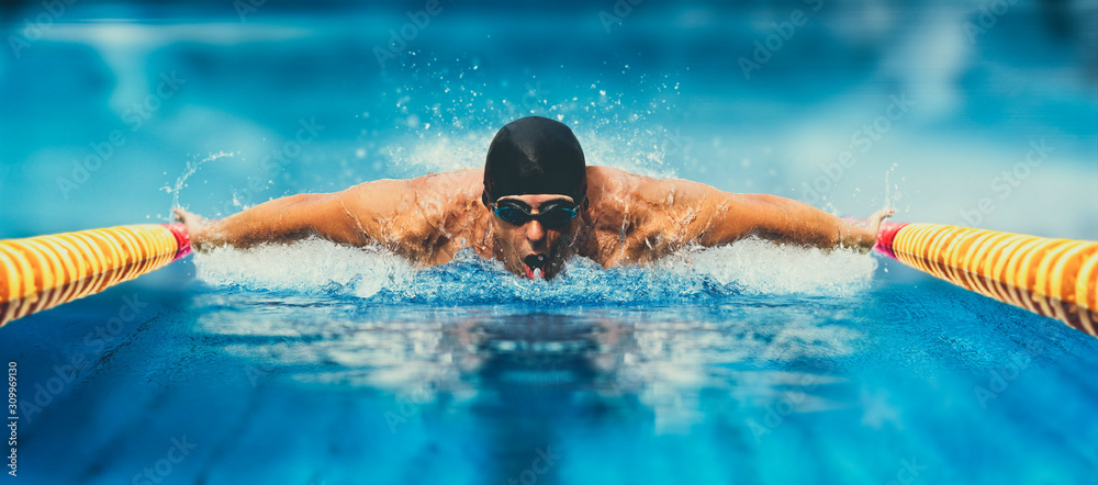 Man in swimming pool. Butterfly style. Matte effect