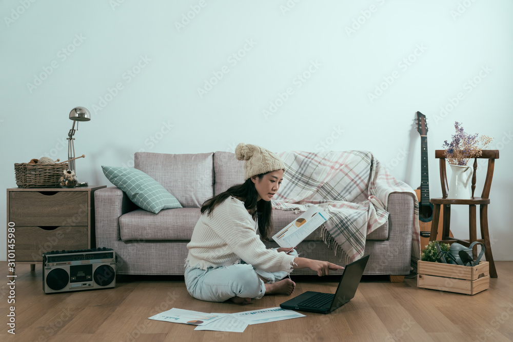 copy space side view portrait of young asian japanese woman sitting on floor indoor working on lapto