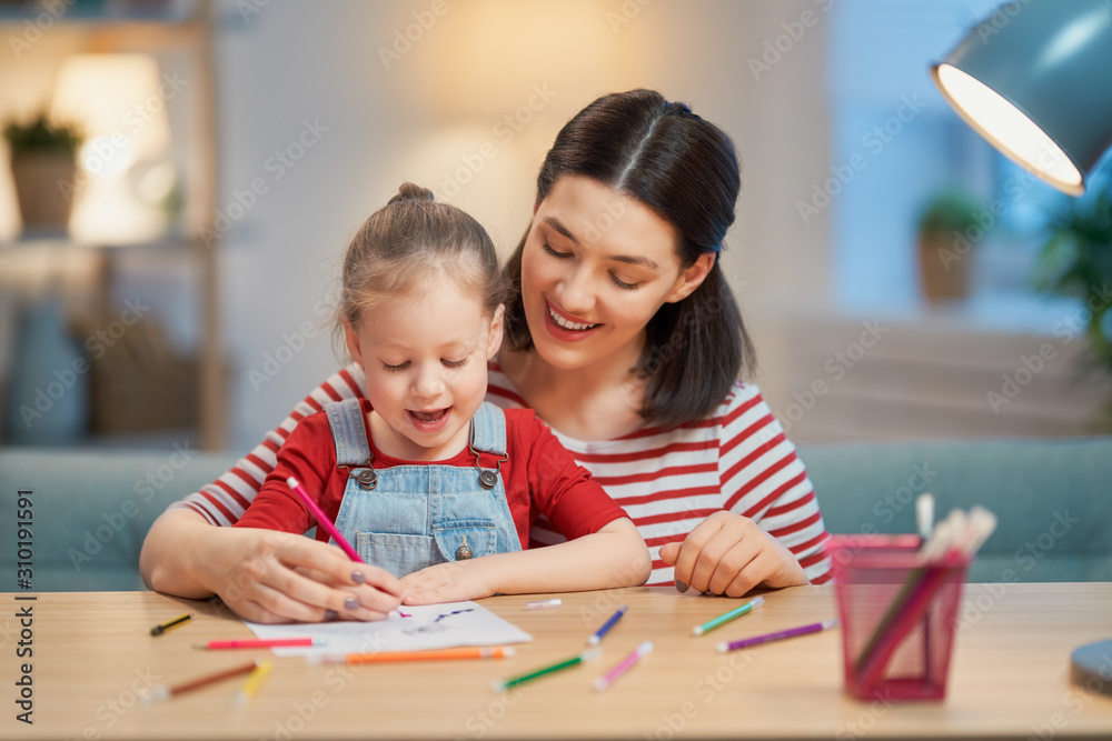 Girl doing homework with mother