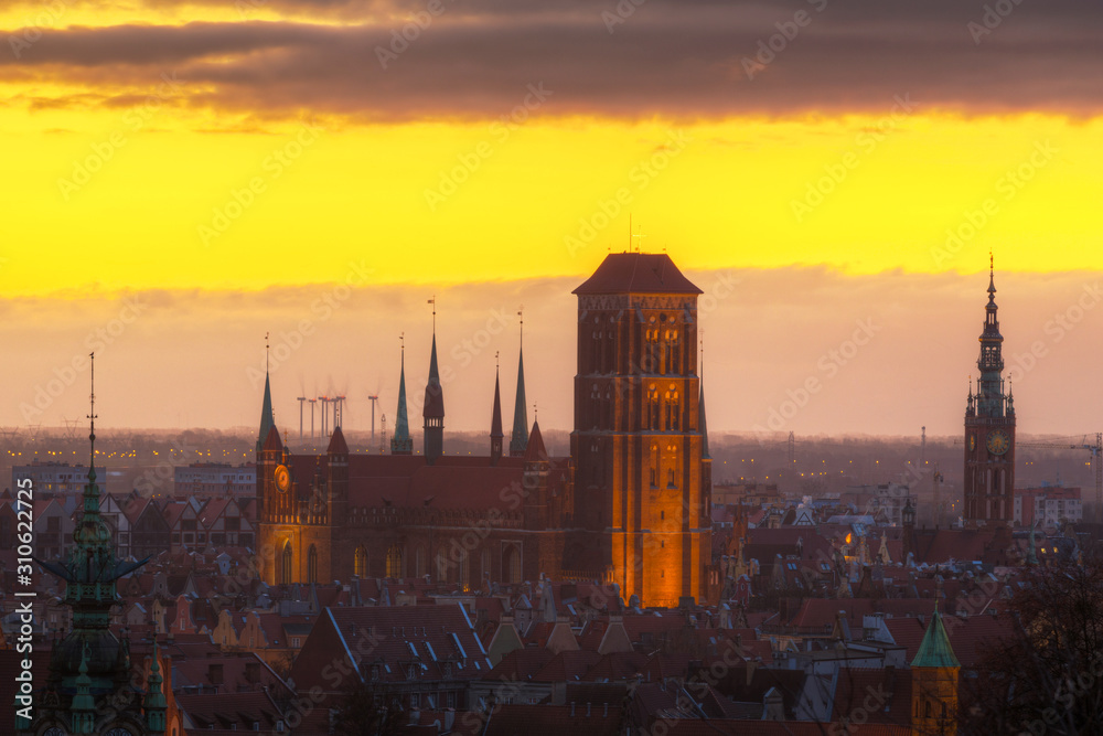 Beautiful cityscape of Gdansk with St. Mary Basilica and City Hall at sunrise, Poland.