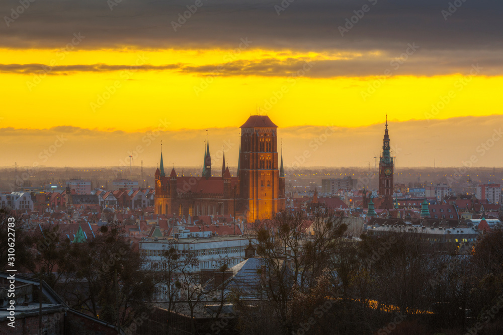 Beautiful cityscape of Gdansk with St. Mary Basilica and City Hall at sunrise, Poland.